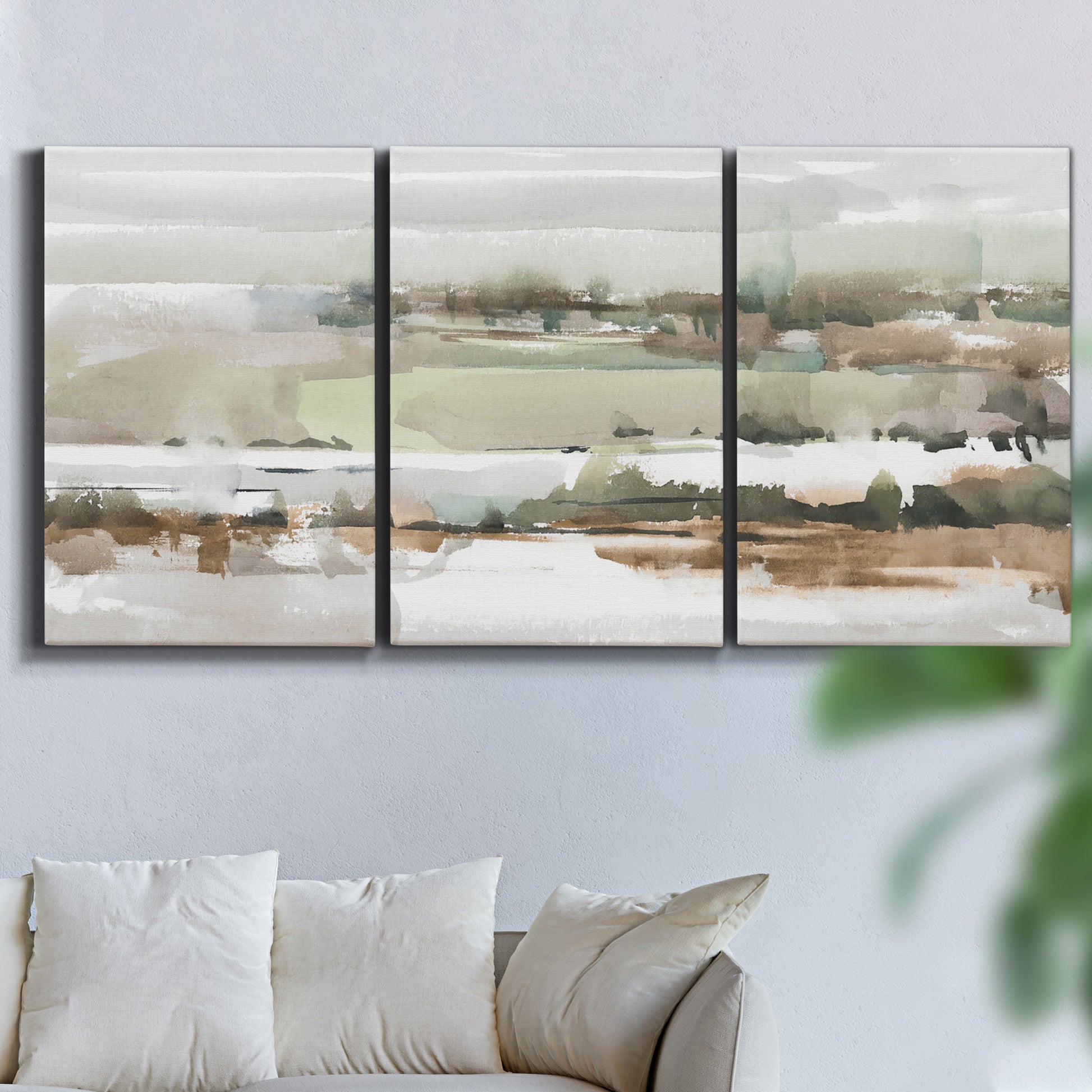 Three-panel canvas wall art featuring layered turquoise and earth tones abstract, displayed in a living room above a sofa.