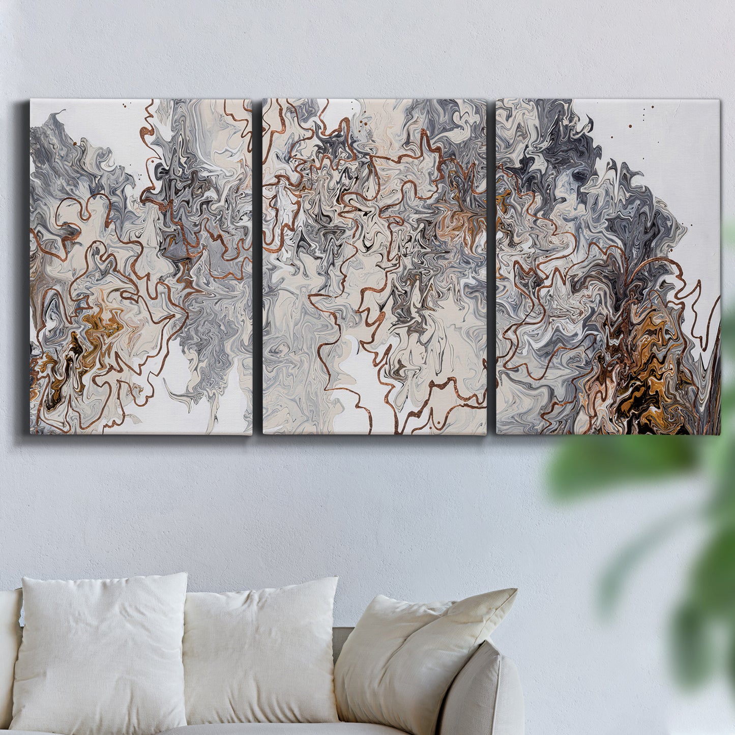 Three-panel canvas wall art featuring wooded trail through forest, displayed in a living room above a sofa.