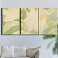 Three-panel canvas wall art featuring minimal verdant floral abstraction, displayed in a living room above a sofa.