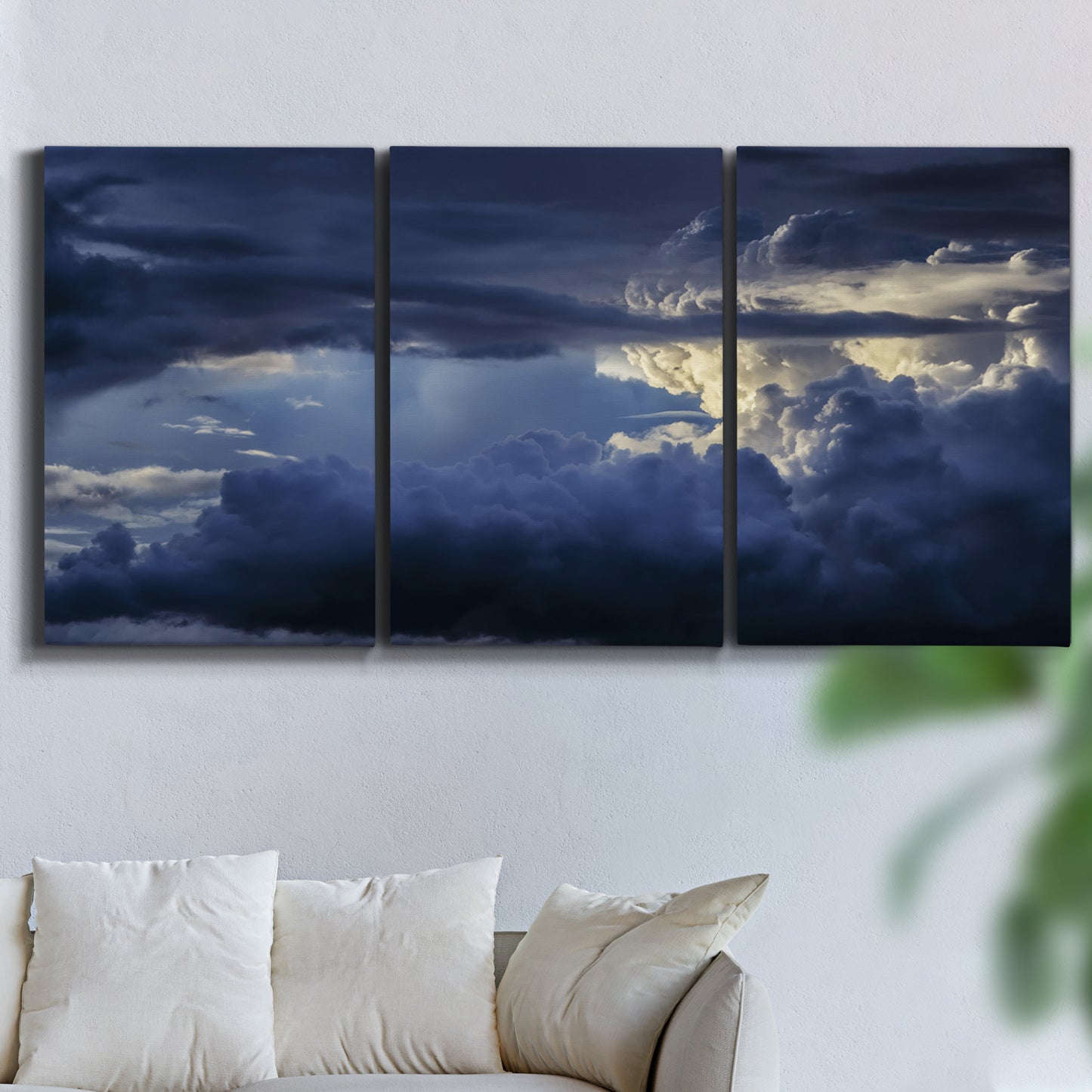 Three-panel canvas wall art featuring hot air balloons rising at dawn, displayed in a living room above a sofa.