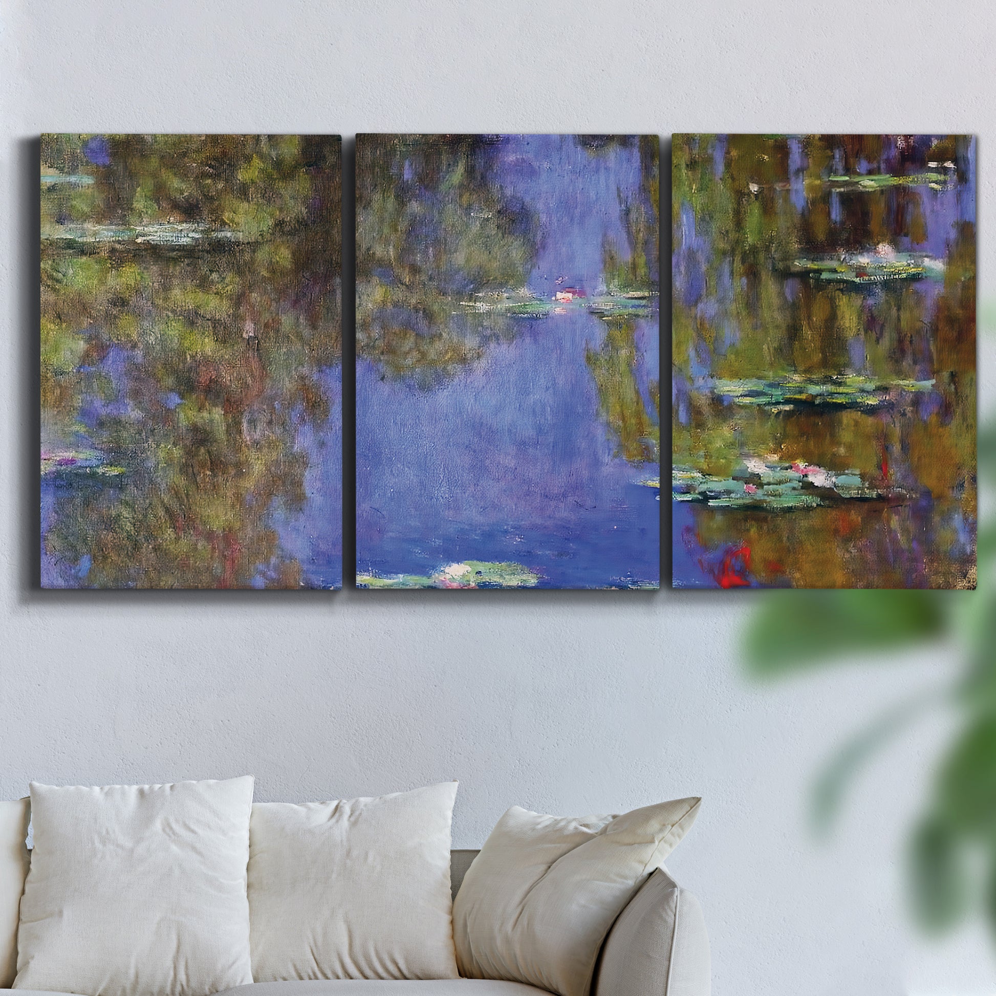 Three-panel canvas wall art featuring blue and purple water lily pond, displayed in a living room above a sofa.