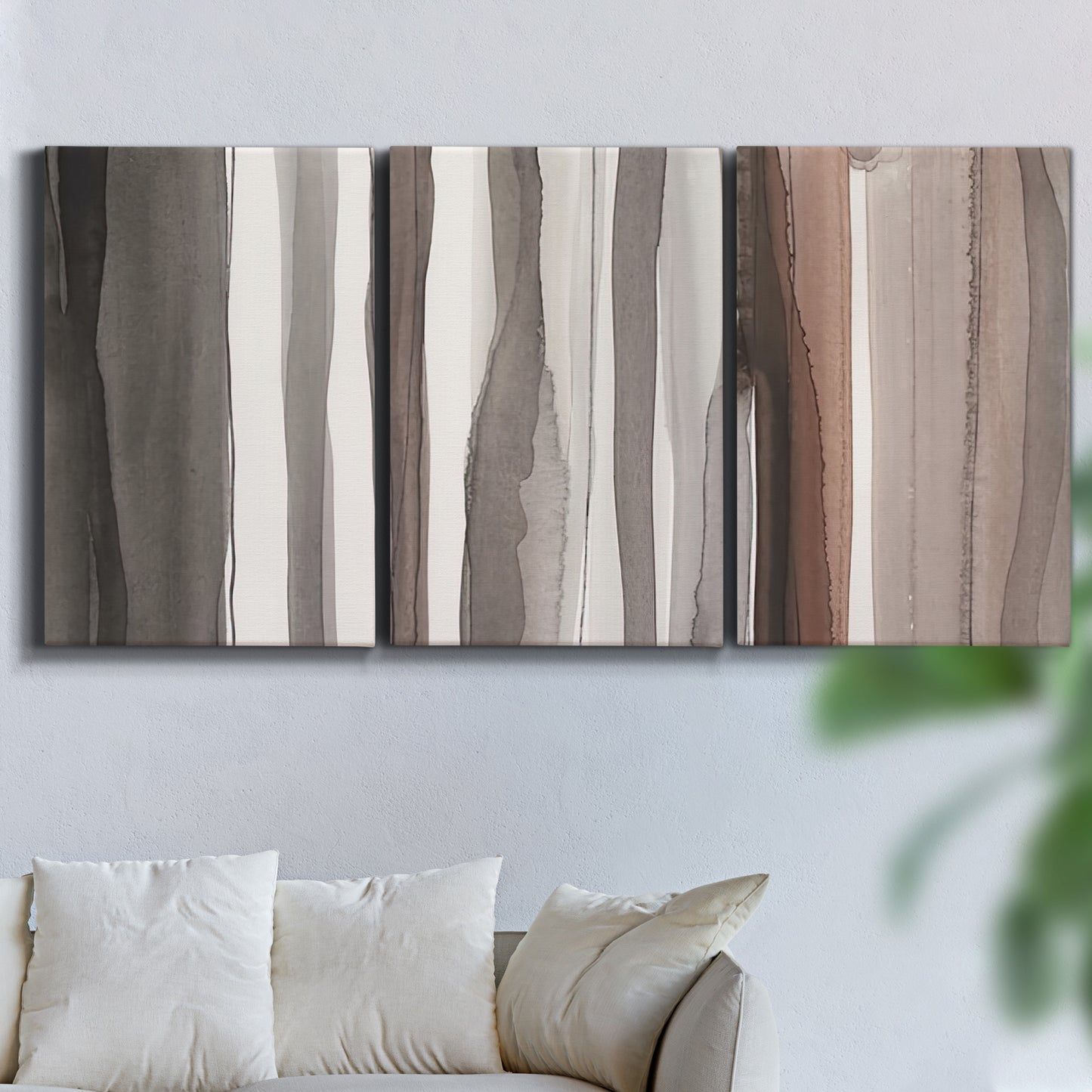 Three-panel canvas wall art featuring riverbank landscape with reflections, displayed in a living room above a sofa.
