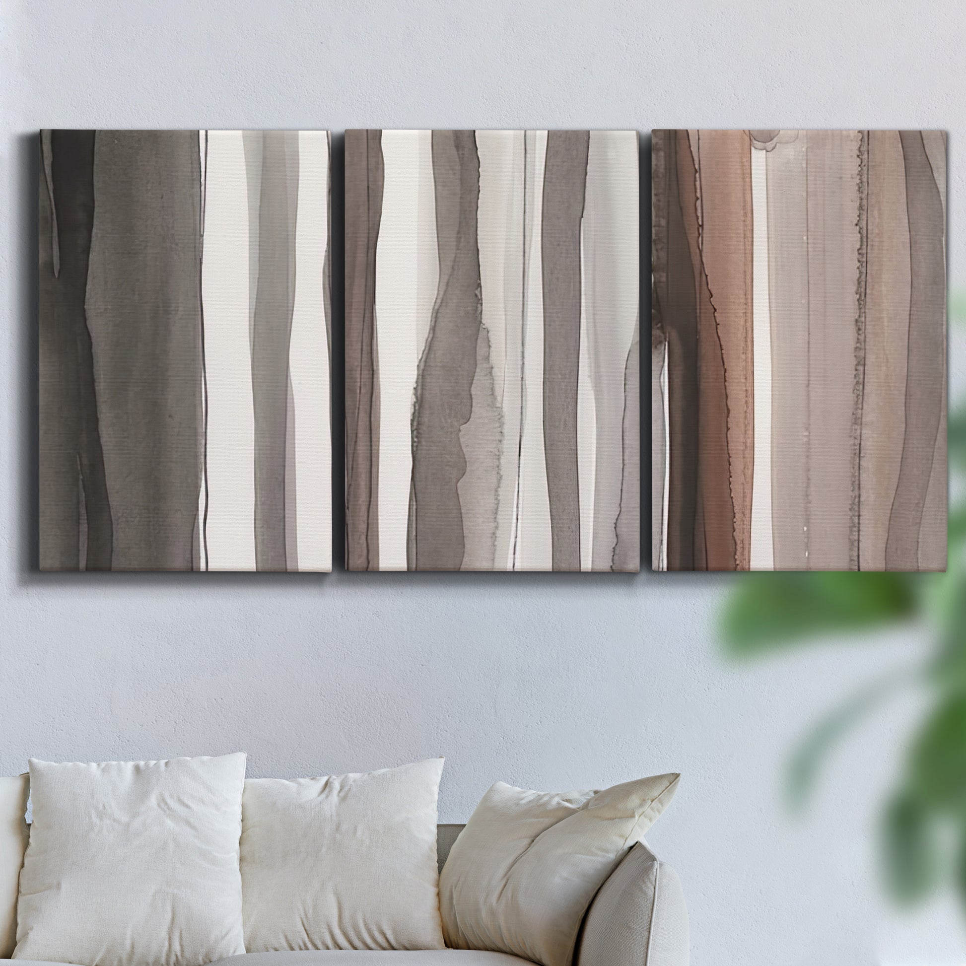 Three-panel canvas wall art featuring riverbank landscape with reflections, displayed in a living room above a sofa.