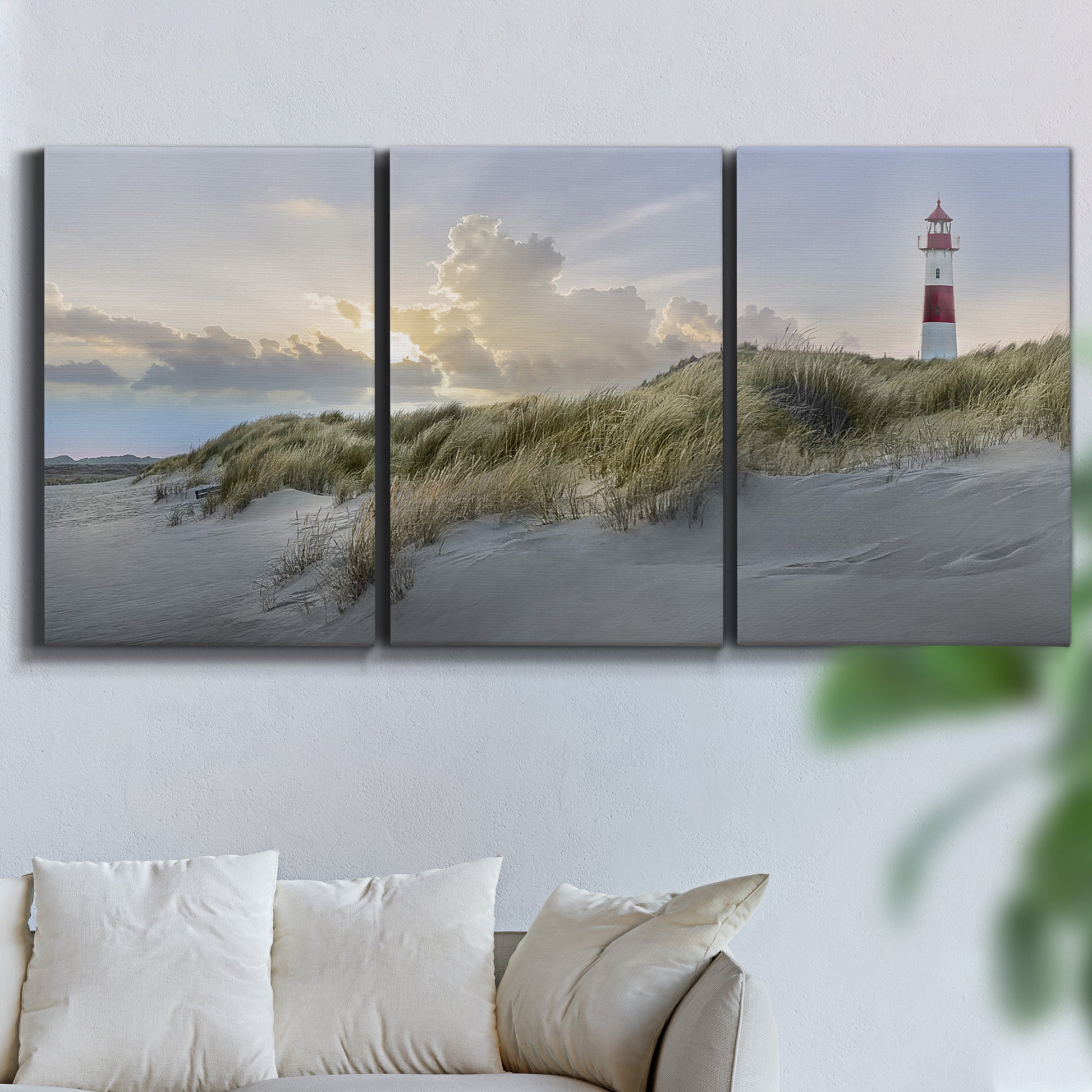 Three-panel canvas wall art featuring guardian boat along shoreline, displayed in a living room above a sofa.