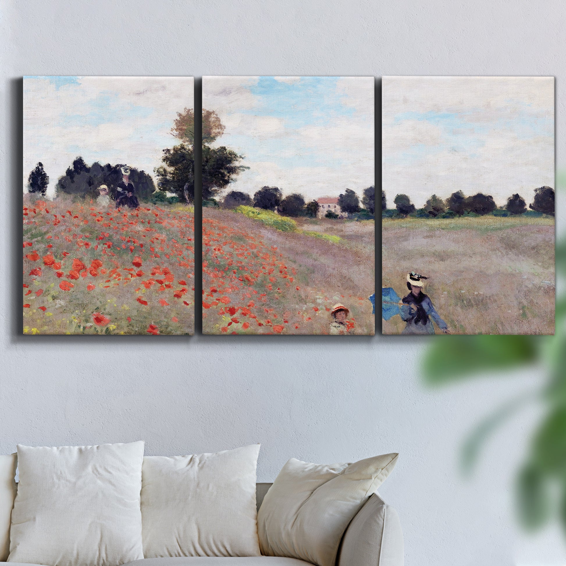 Three-panel canvas wall art featuring poppy field stretching across meadow, displayed in a living room above a sofa.