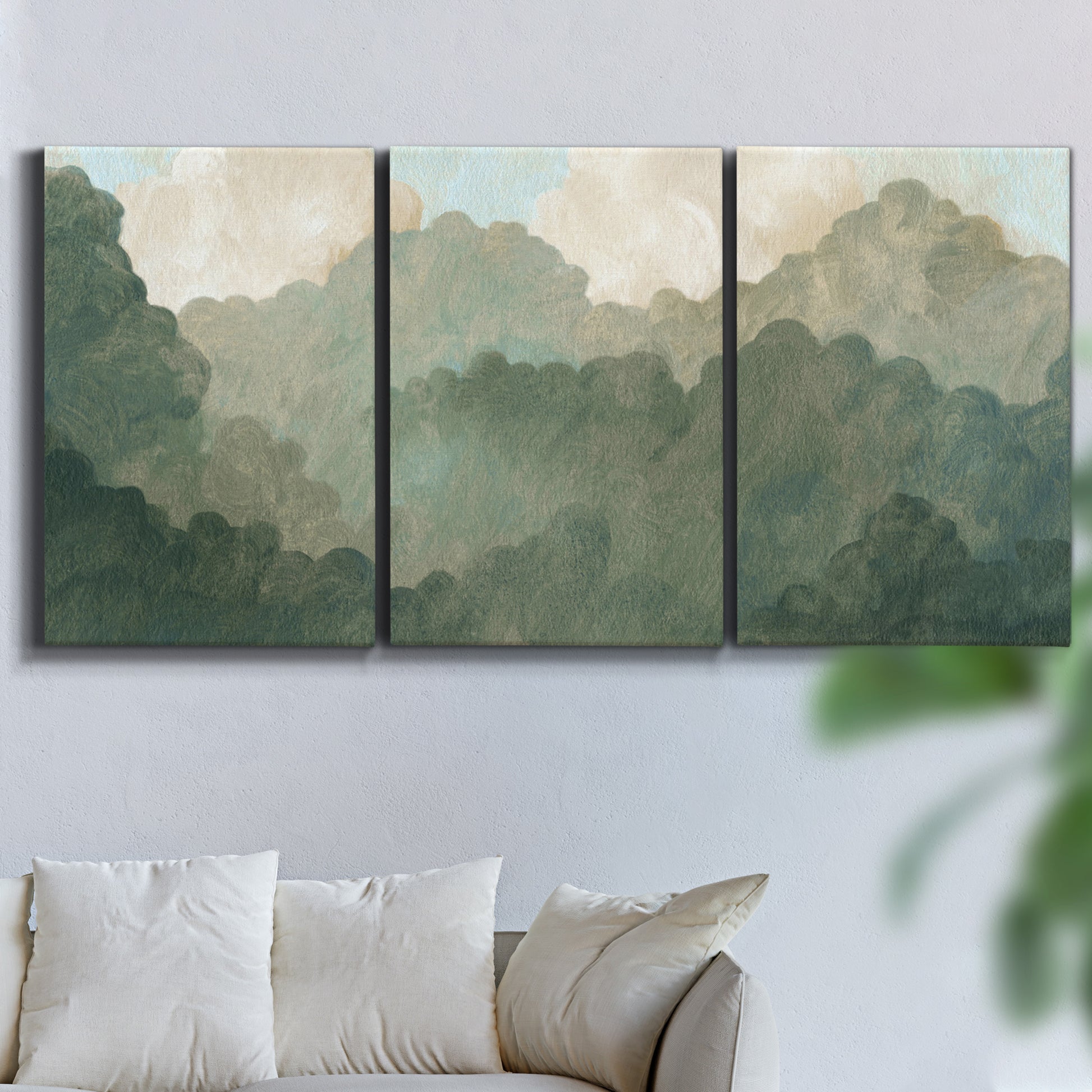 Three-panel canvas wall art featuring autumn storm over rolling landscape, displayed in a living room above a sofa.