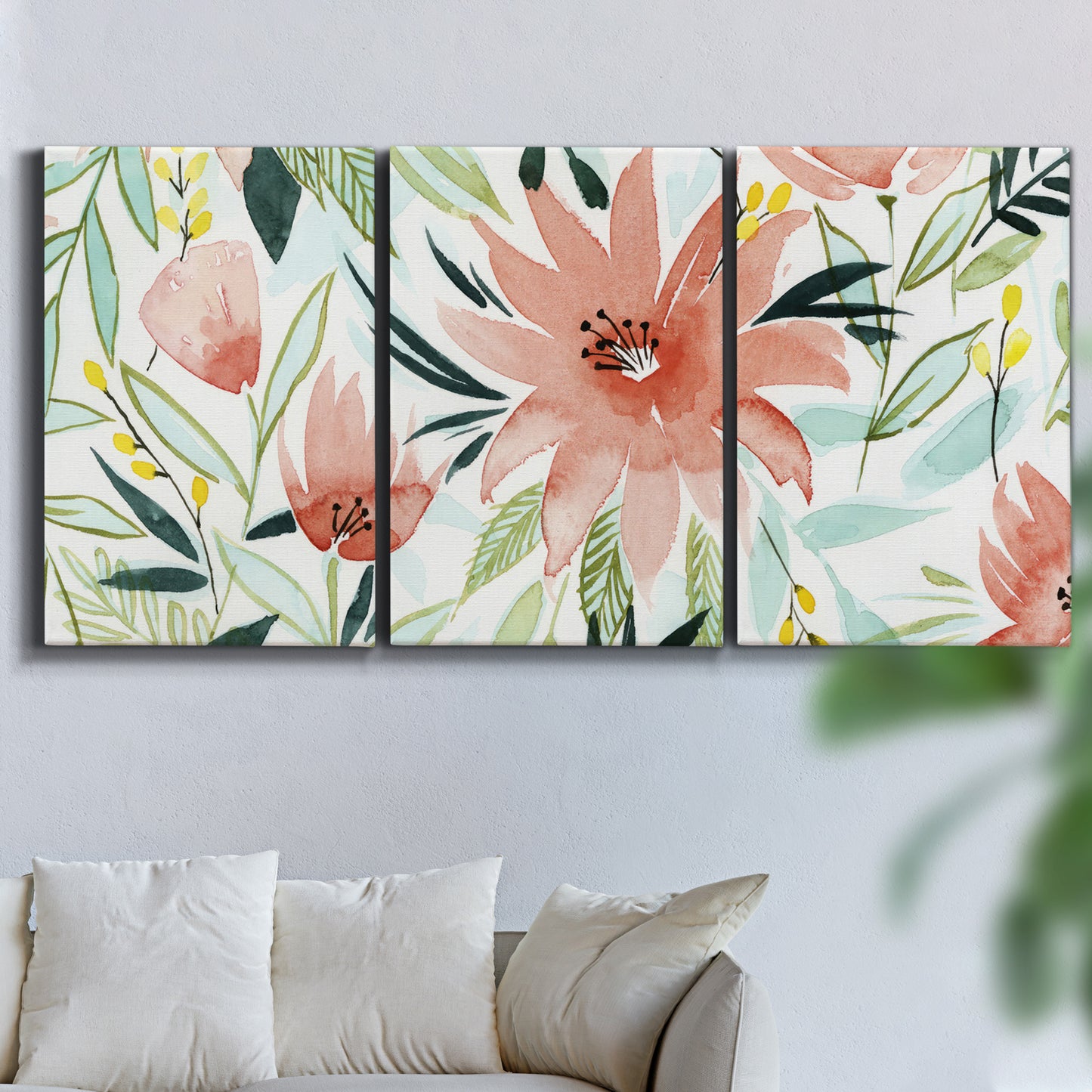 Three-panel canvas wall art featuring tropical botanical collage, displayed in a living room above a sofa.