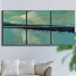 Three-panel canvas wall art featuring calm harbor water with glowing horizon, displayed in a living room above a sofa.