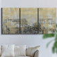 Three-panel canvas wall art featuring gold toned abstract horizon, displayed in a living room above a sofa.