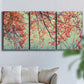 Three-panel canvas wall art featuring autumn foliage landscape photograph, displayed in a living room above a sofa.