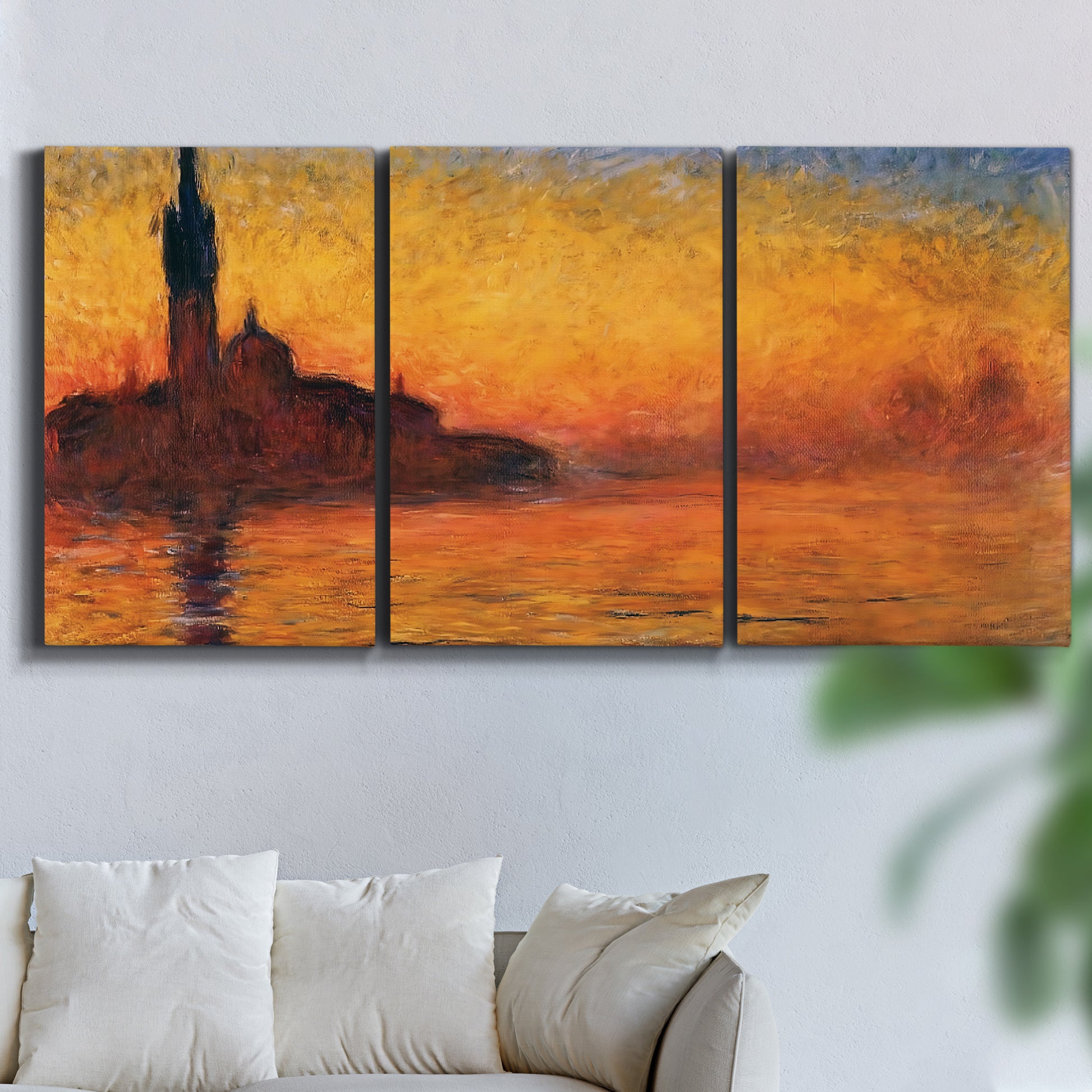 Three-panel canvas wall art featuring Venetian church at sunset, displayed in a living room above a sofa.