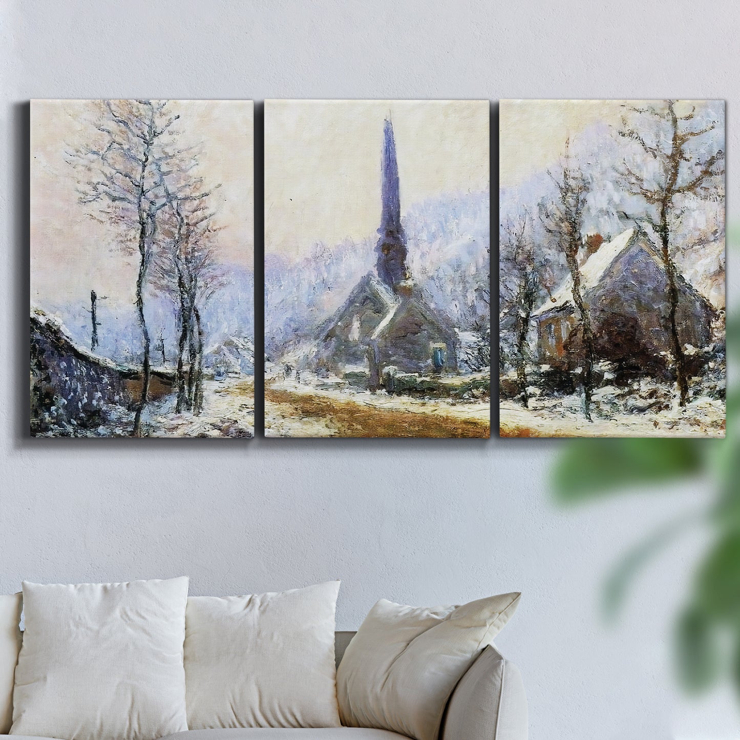 Three-panel canvas wall art featuring snow covered road leading to village, displayed in a living room above a sofa.
