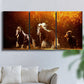 Three-panel canvas wall art featuring running horses across open field, displayed in a living room above a sofa.