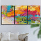 Three-panel canvas wall art featuring expressive abstract sunset tones, displayed in a living room above a sofa.