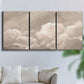 Three-panel canvas wall art featuring soft whimsical cloudscape, displayed in a living room above a sofa.