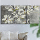Three-panel canvas wall art featuring delicate floral symbolic arrangement, displayed in a living room above a sofa.