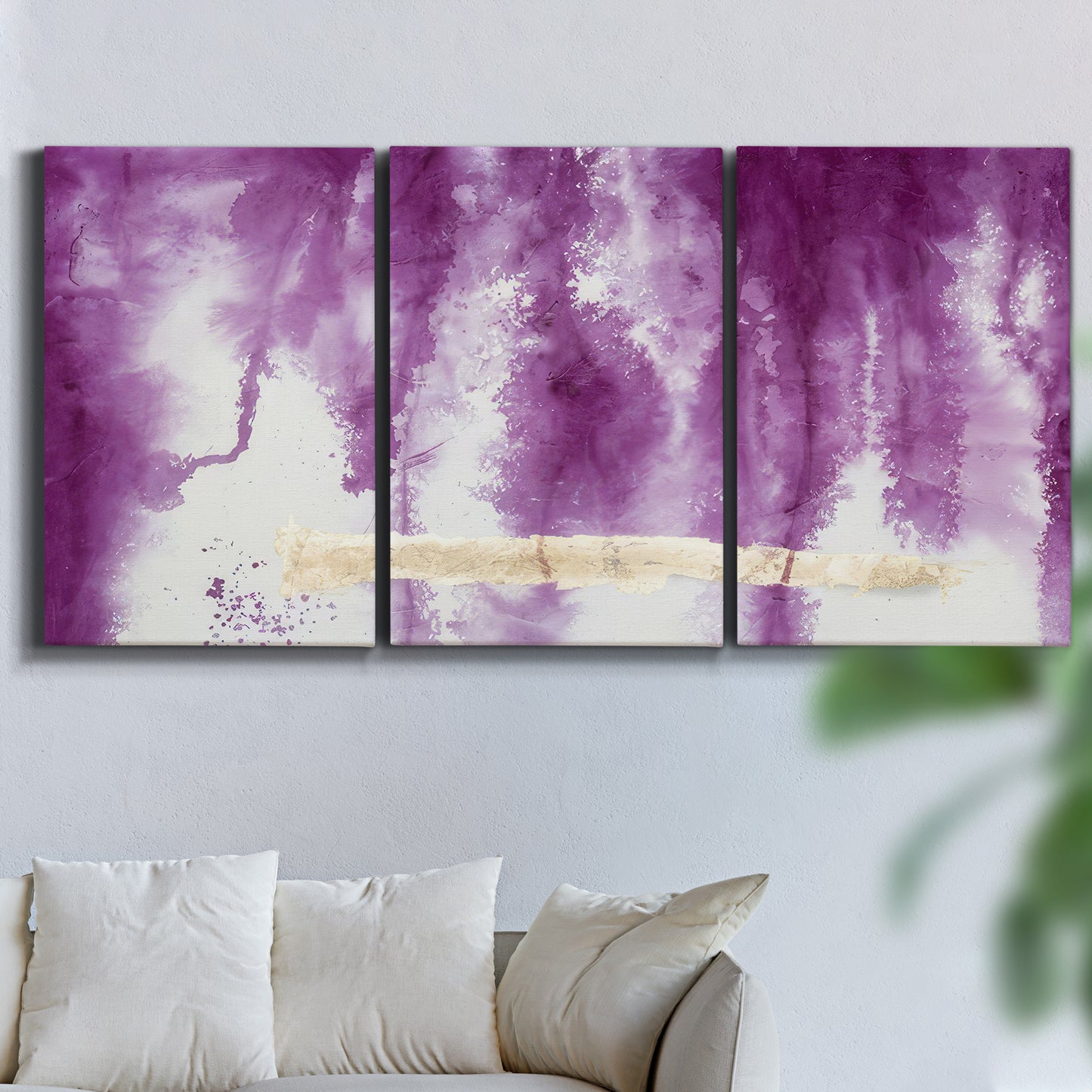 Three-panel canvas wall art featuring saturated abstract color fields, displayed in a living room above a sofa.