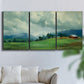 Three-panel canvas wall art featuring wide pastoral valley landscape, displayed in a living room above a sofa.
