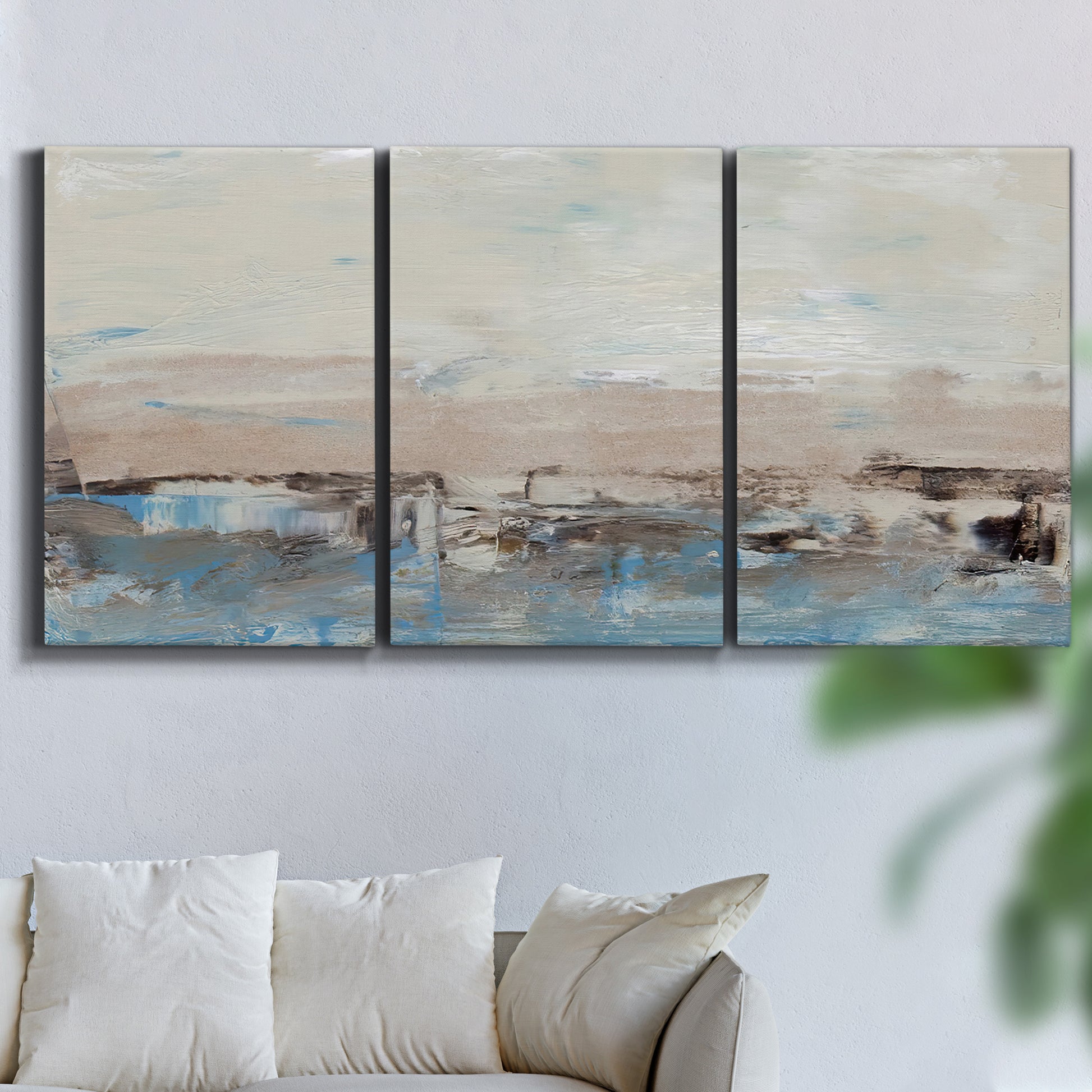 Three-panel canvas wall art featuring abstract bridge landscape in cyan, displayed in a living room above a sofa.