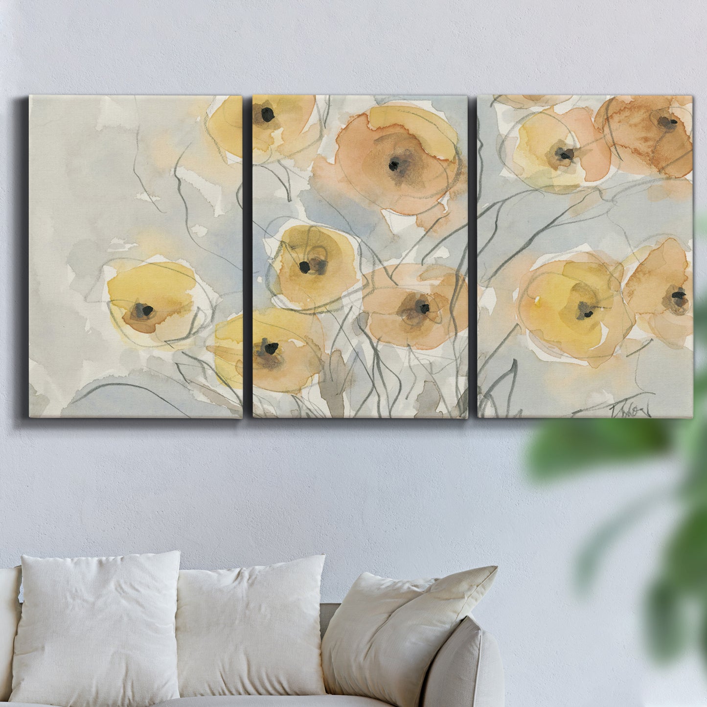 Three-panel canvas wall art featuring minimalist poppies at sunset, displayed in a living room above a sofa.