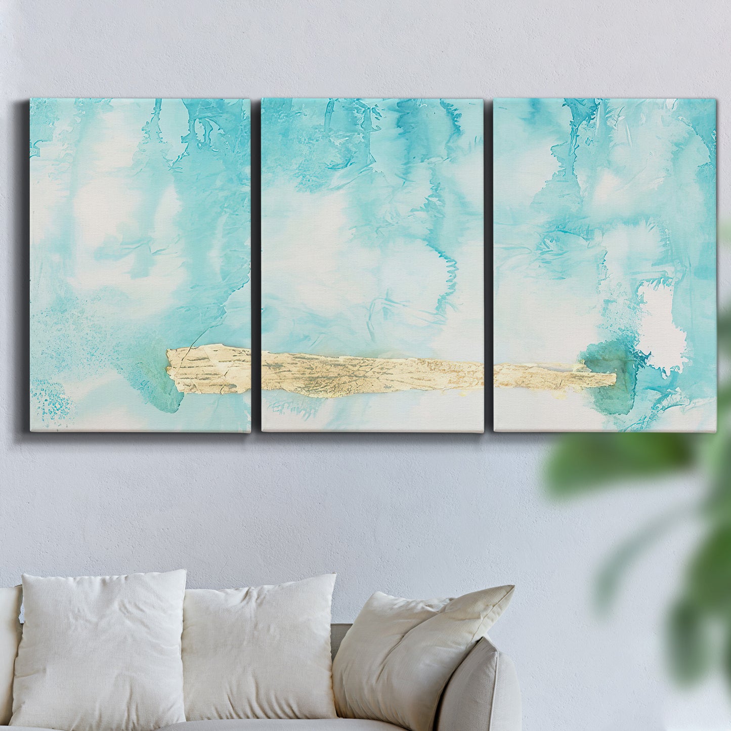 Three-panel canvas wall art featuring saturated abstract color fields, displayed in a living room above a sofa.