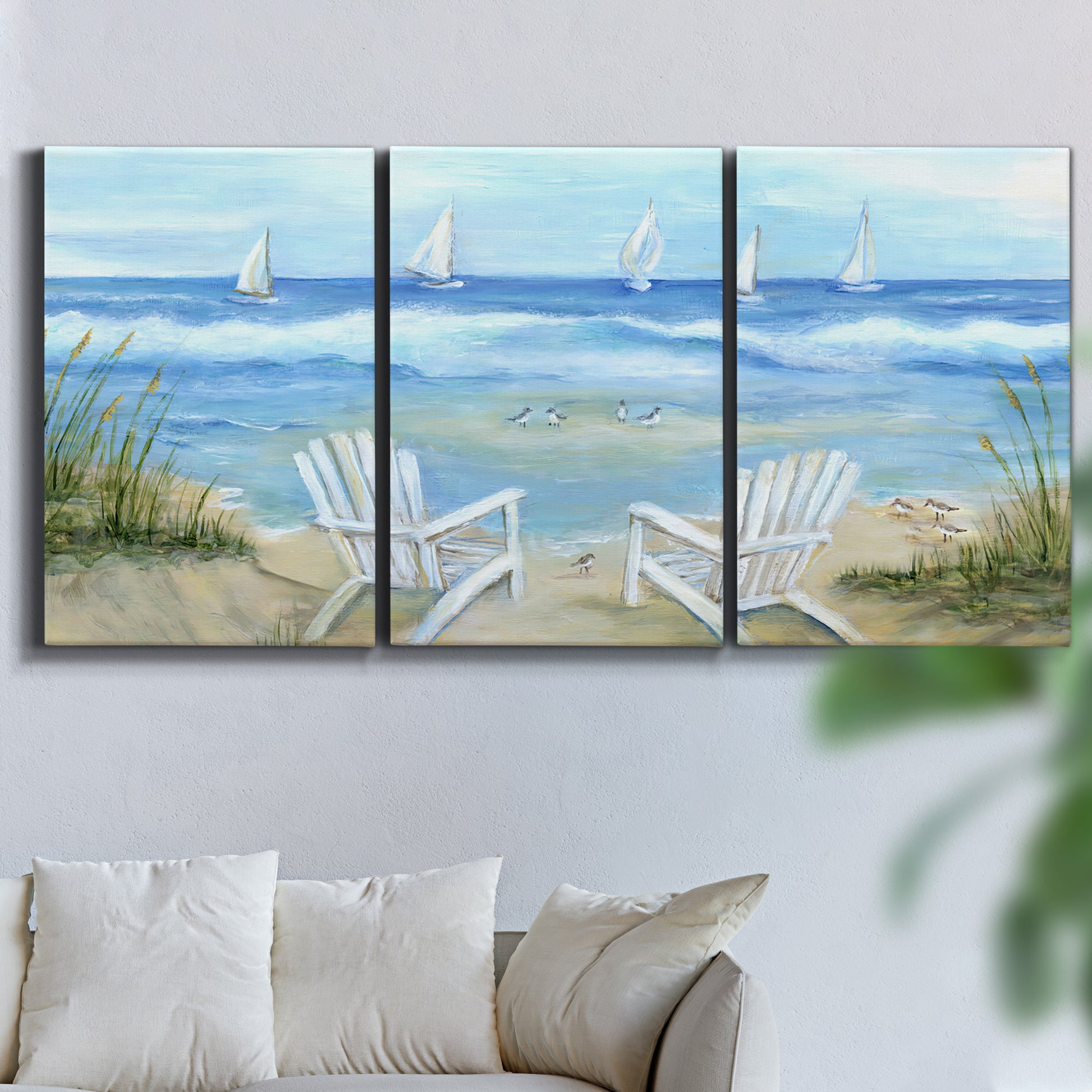 Three-panel canvas wall art featuring peaceful coastal landscape escape, displayed in a living room above a sofa.