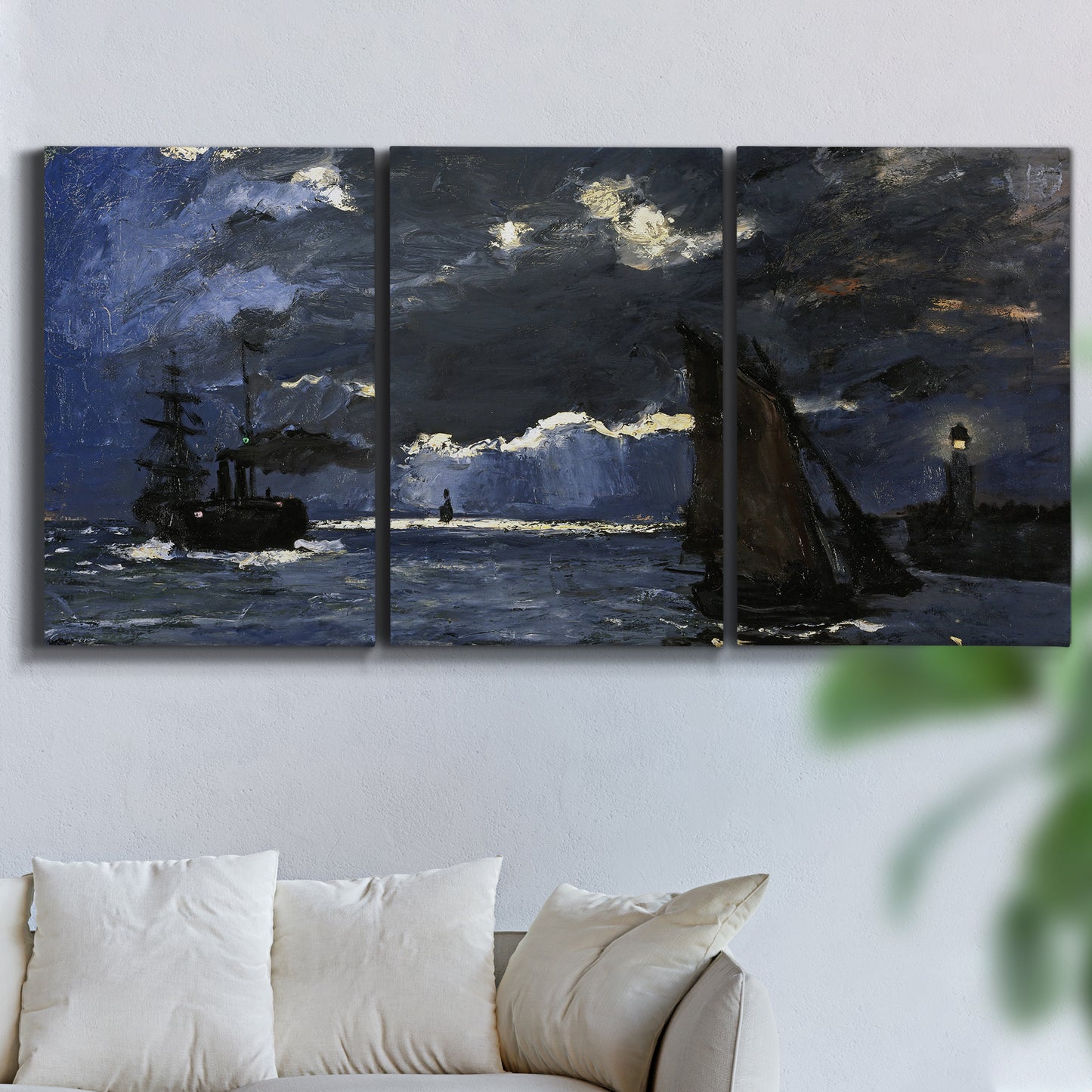 Three-panel canvas wall art featuring dark seascape under night sky, displayed in a living room above a sofa.