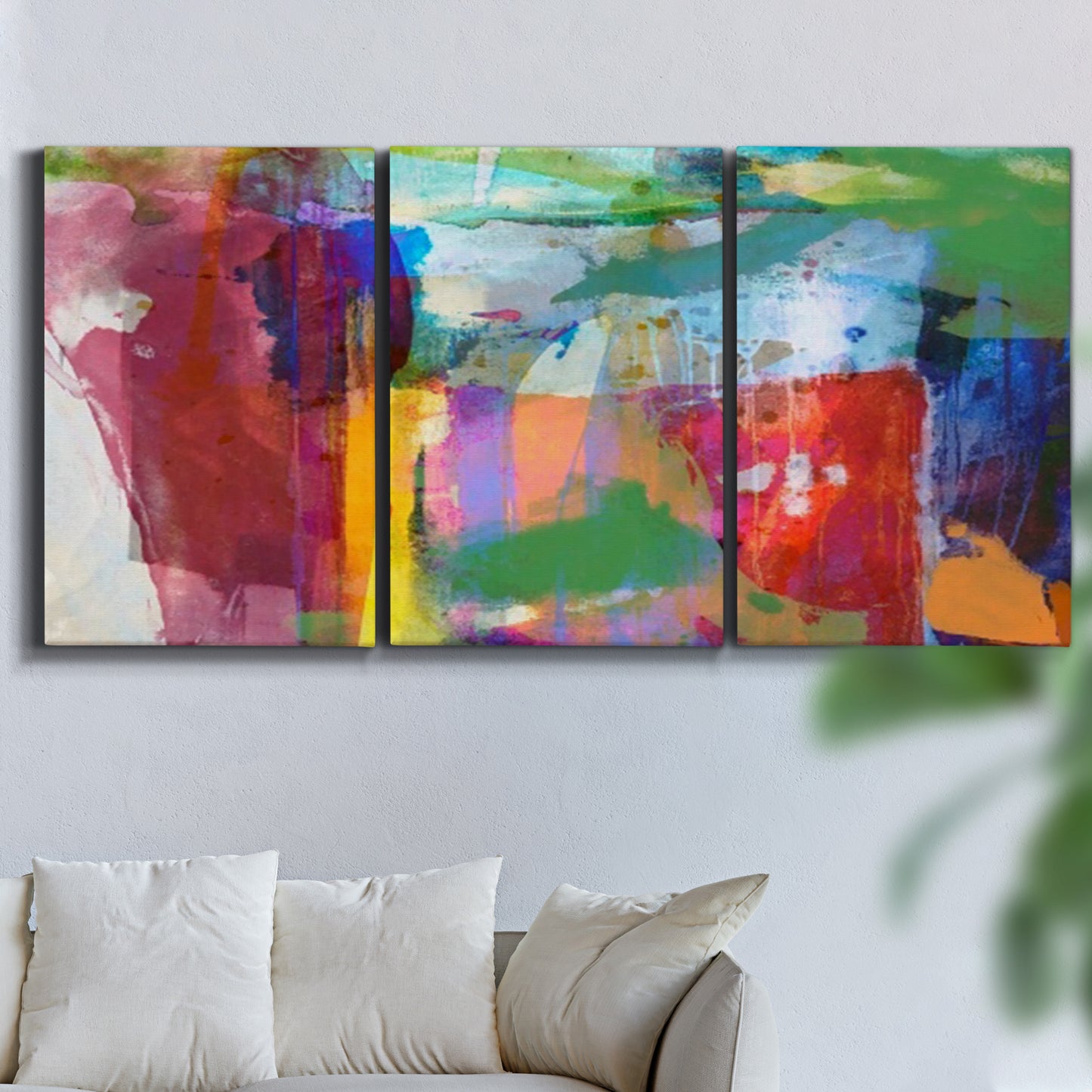 Three-panel canvas wall art featuring vibrant abstract color field panels, displayed in a living room above a sofa.