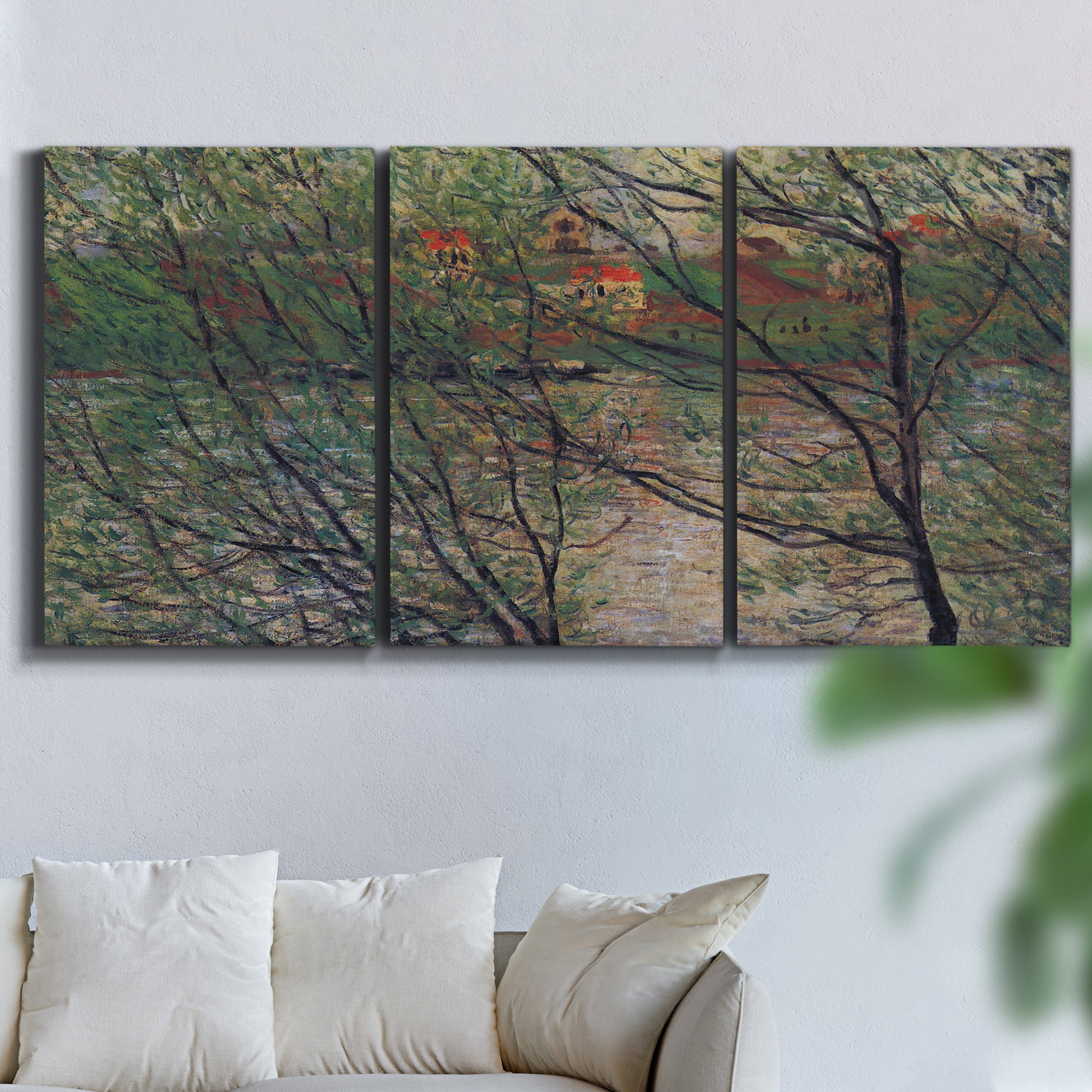 Three-panel canvas wall art featuring spring countryside with fresh foliage, displayed in a living room above a sofa.