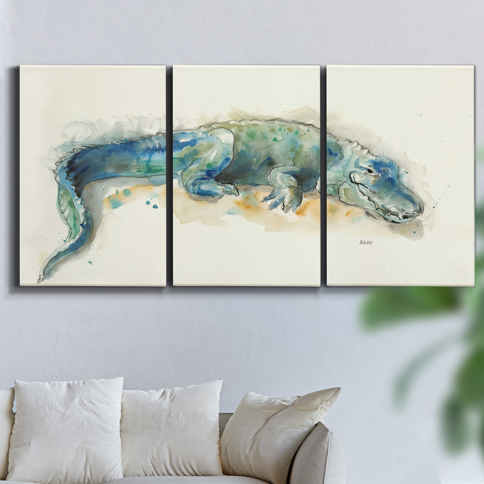 Three-panel canvas wall art featuring alligator illustrated wildlife portrait, displayed in a living room above a sofa.