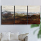Three-panel canvas wall art featuring rustic abstract landscape exploration, displayed in a living room above a sofa.