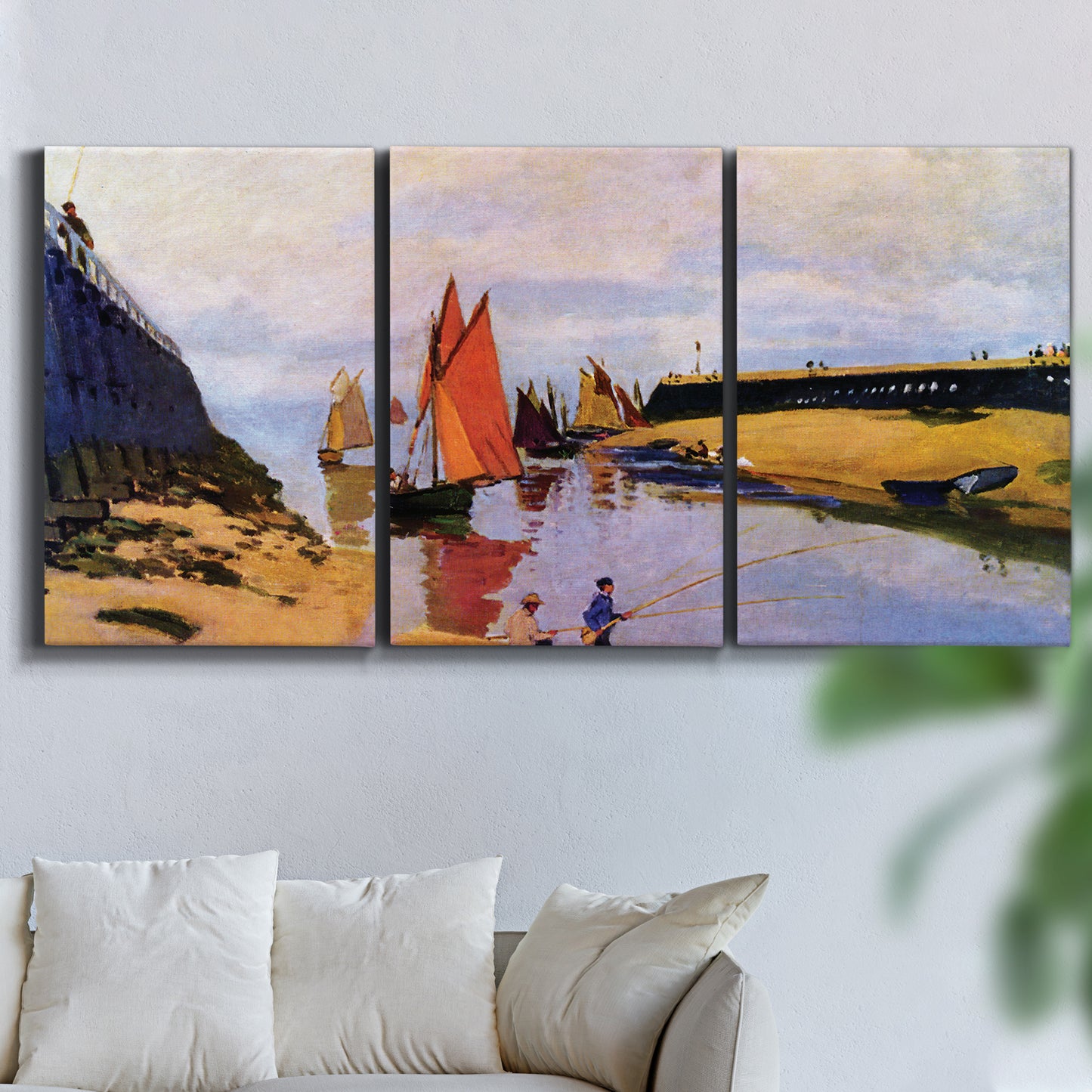 Three-panel canvas wall art featuring stone breakwater at low tide, displayed in a living room above a sofa.