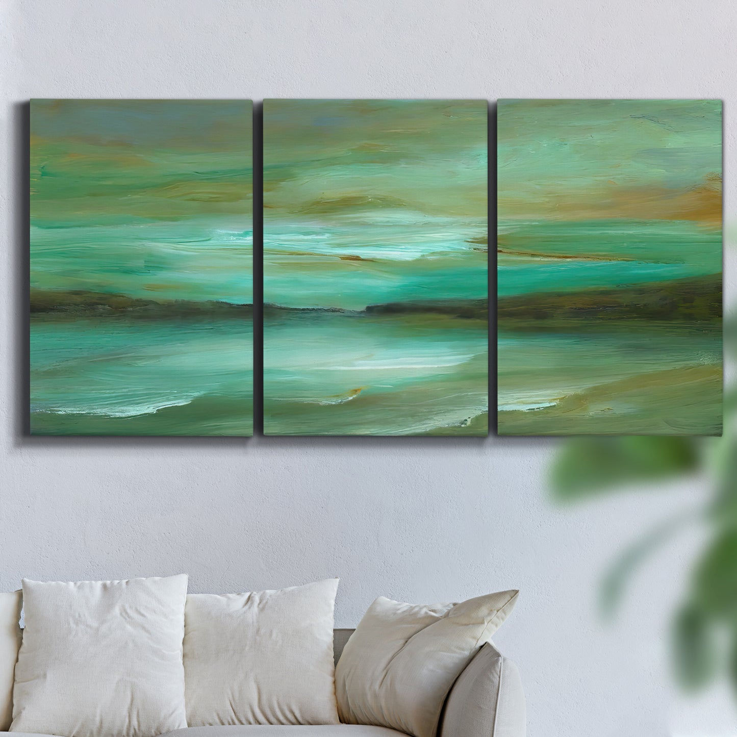 Three-panel canvas wall art featuring hidden coastal cove landscape, displayed in a living room above a sofa.