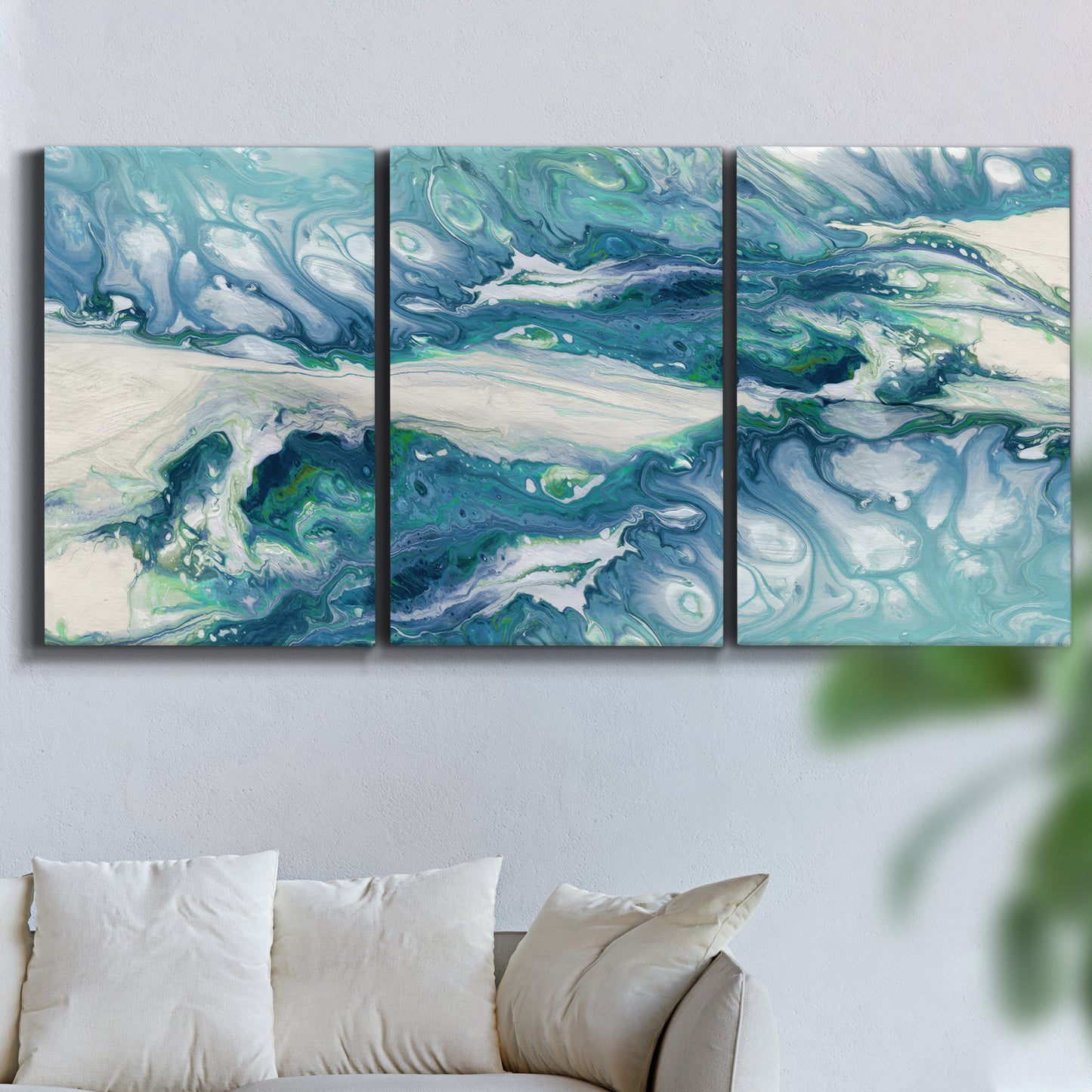 Three-panel canvas wall art featuring layered abstract marble textures, displayed in a living room above a sofa.