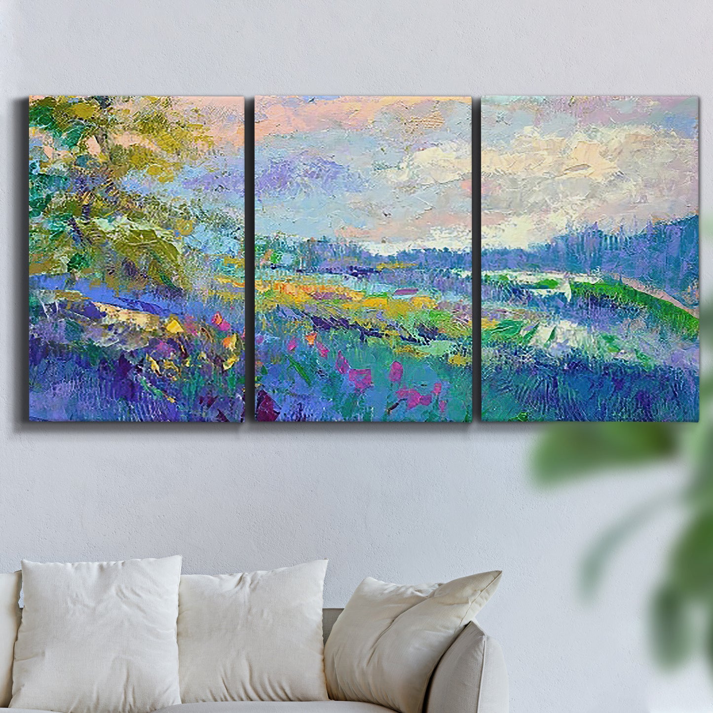 Three-panel canvas wall art featuring cheerful landscape under open sky, displayed in a living room above a sofa.