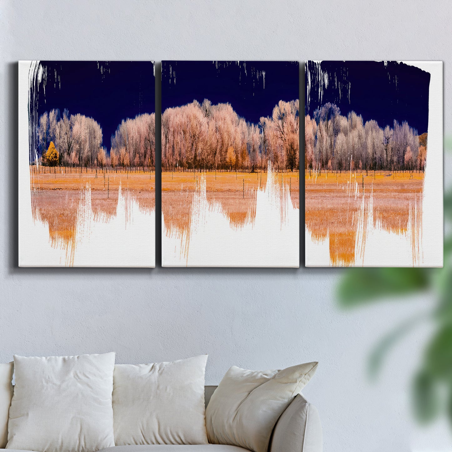 Three-panel canvas wall art featuring panoramic treeline landscape photograph, displayed in a living room above a sofa.