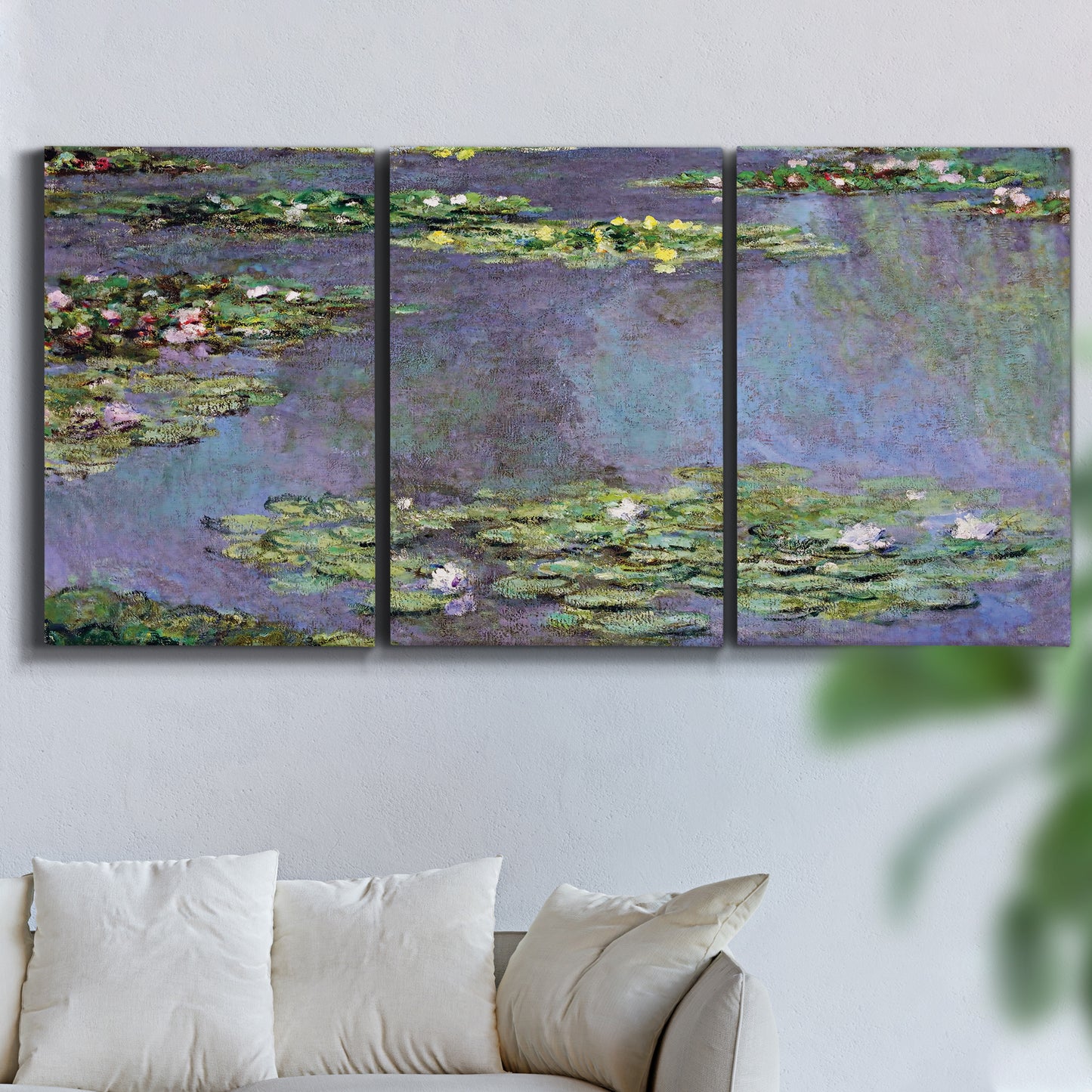 Three-panel canvas wall art featuring purple haze water lily pond, displayed in a living room above a sofa.