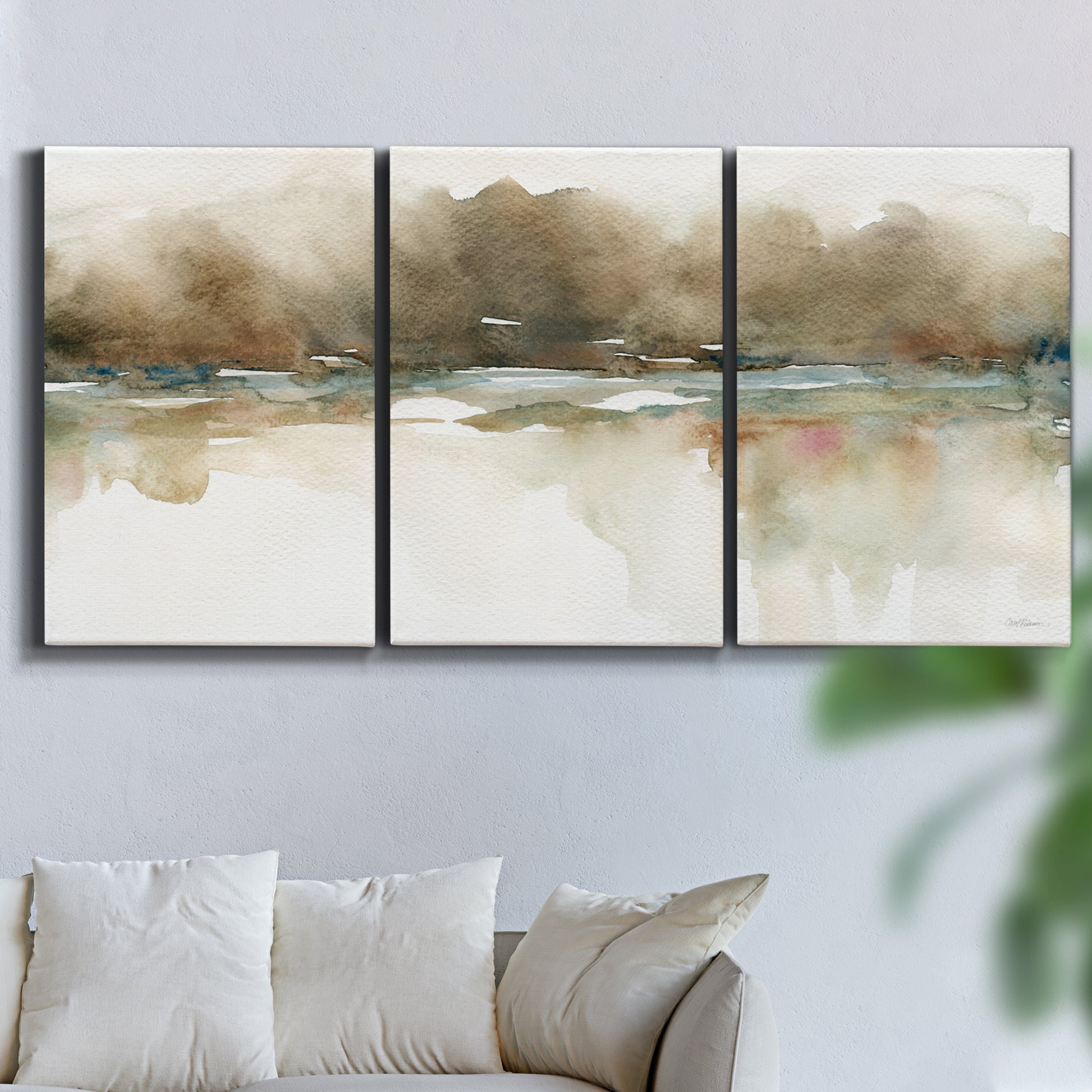 Three-panel canvas wall art featuring soft abstract mirrored reflections, displayed in a living room above a sofa.