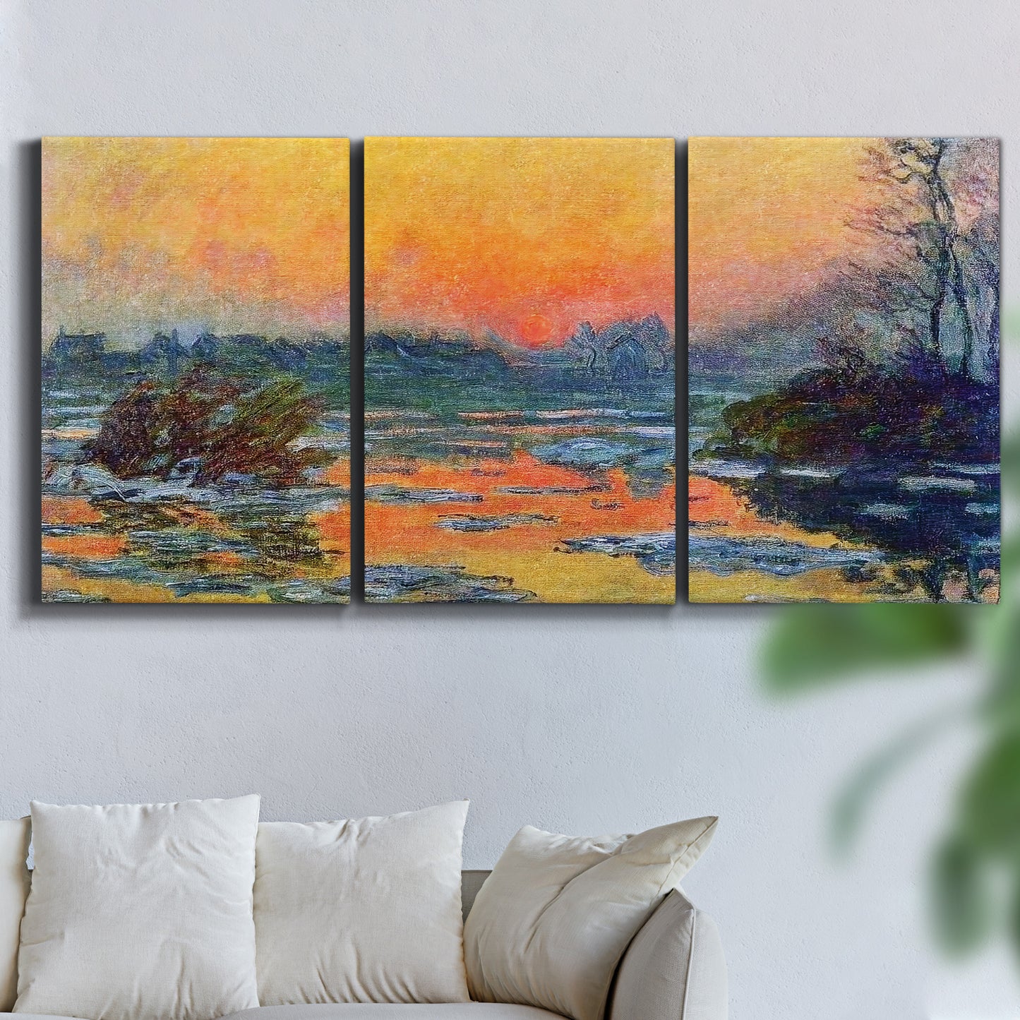 Three-panel canvas wall art featuring winter sunset over river, displayed in a living room above a sofa.