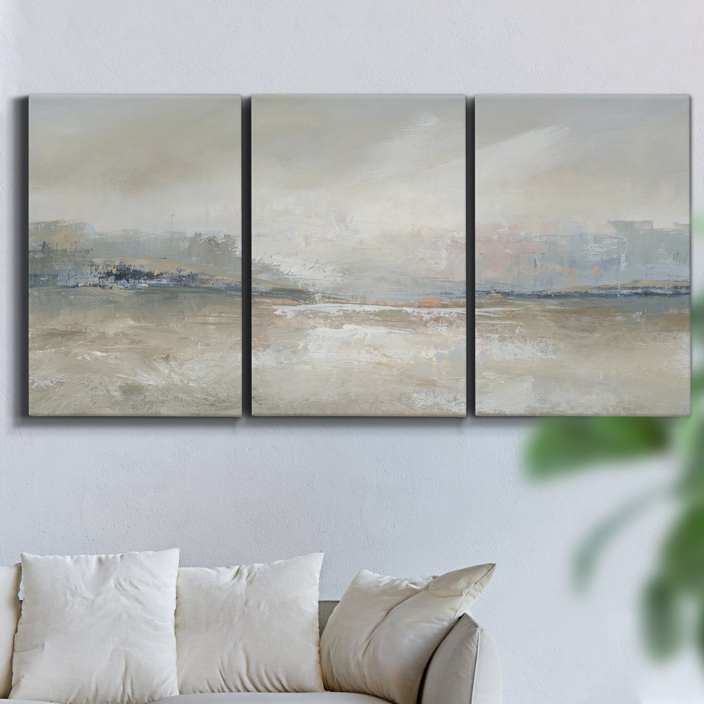 Three-panel canvas wall art featuring soft abstract horizon haze, displayed in a living room above a sofa.