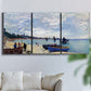 Three-panel canvas wall art featuring busy beach scene with shoreline, displayed in a living room above a sofa.