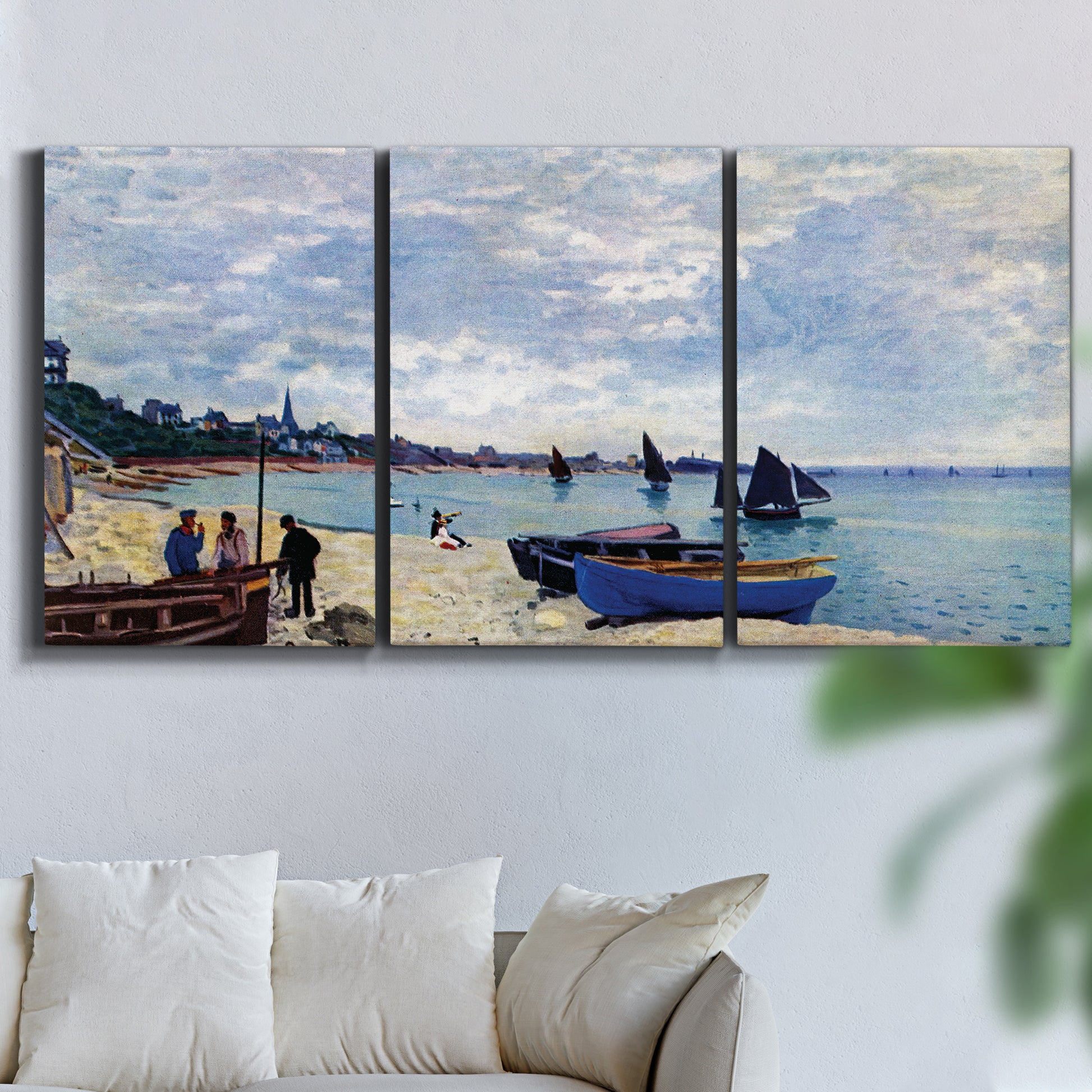 Three-panel canvas wall art featuring busy beach scene with shoreline, displayed in a living room above a sofa.