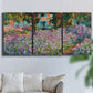 Three-panel canvas wall art featuring blooming irises in garden bed, displayed in a living room above a sofa.