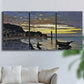 Three-panel canvas wall art featuring river at dusk with fading light, displayed in a living room above a sofa.
