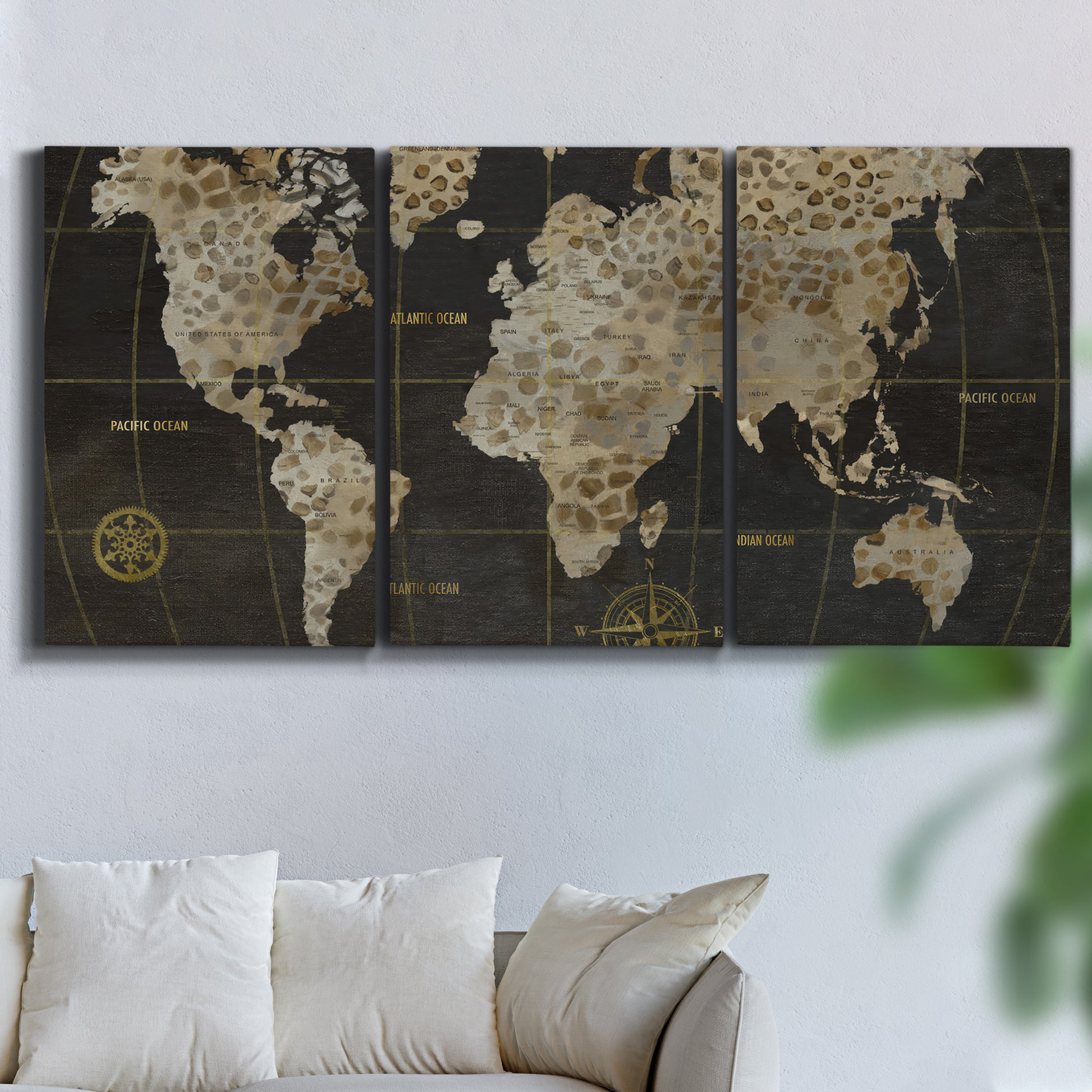 Three-panel canvas wall art featuring illustrated safari world map, displayed in a living room above a sofa.