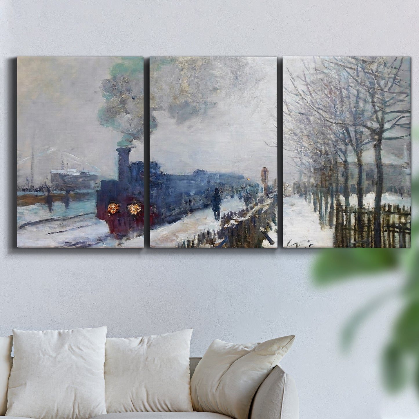 Three-panel canvas wall art featuring steam train in snowy landscape, displayed in a living room above a sofa.