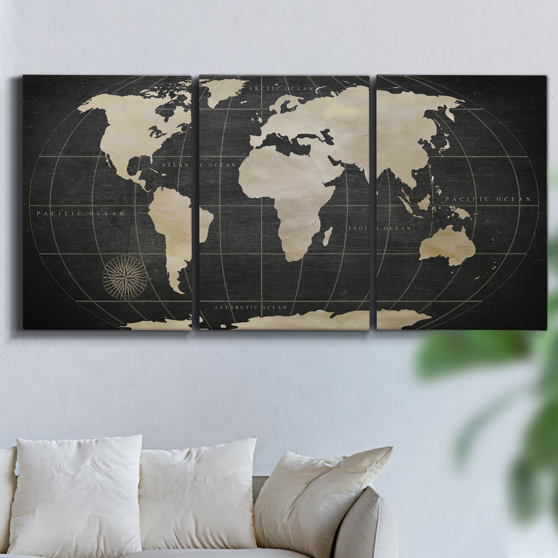 Three-panel canvas wall art featuring antique world map illustration, displayed in a living room above a sofa.