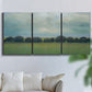 Three-panel canvas wall art featuring rolling green pastoral fields, displayed in a living room above a sofa.