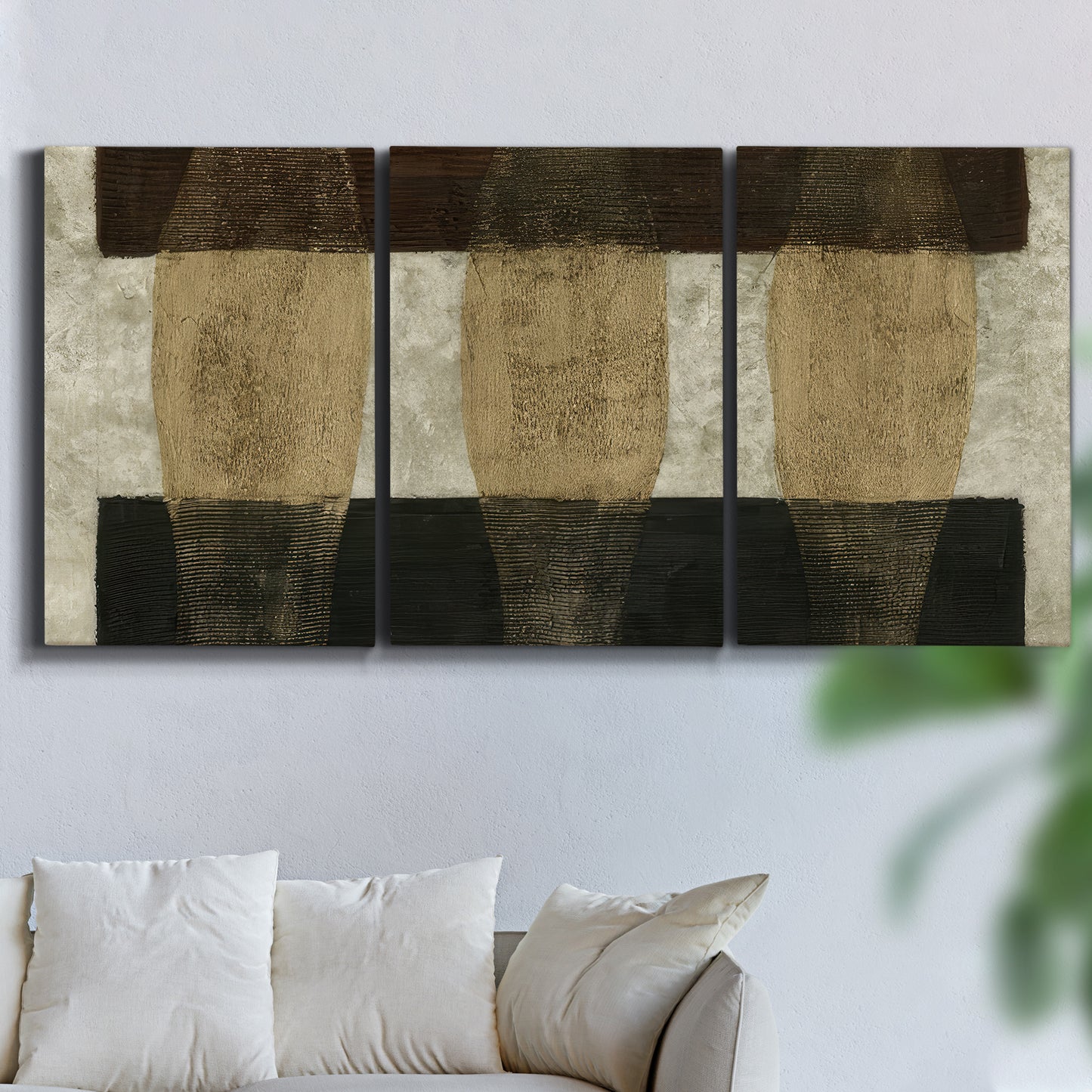 Three-panel canvas wall art featuring textured abstract vessel forms, displayed in a living room above a sofa.