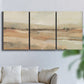 Three-panel canvas wall art featuring earth toned abstract landscape, displayed in a living room above a sofa.
